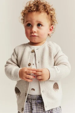 Baby beige knitted cardigan with hedgehog motif