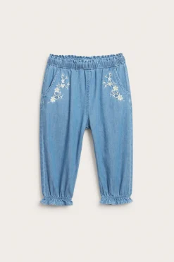 Baby blue denim trousers with floral embroidery