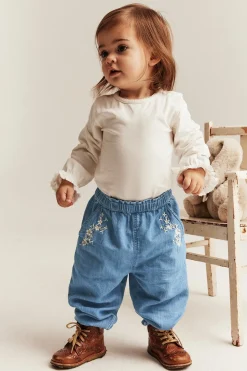 Baby blue denim trousers with floral embroidery