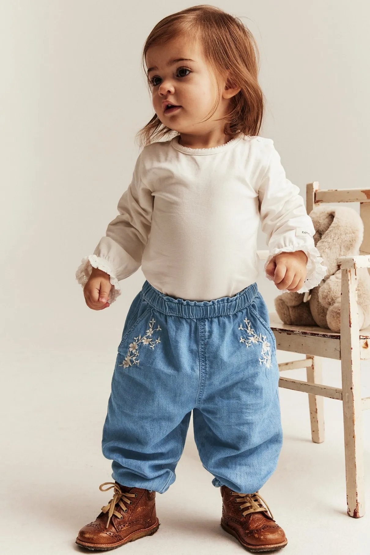 Baby blue denim trousers with floral embroidery