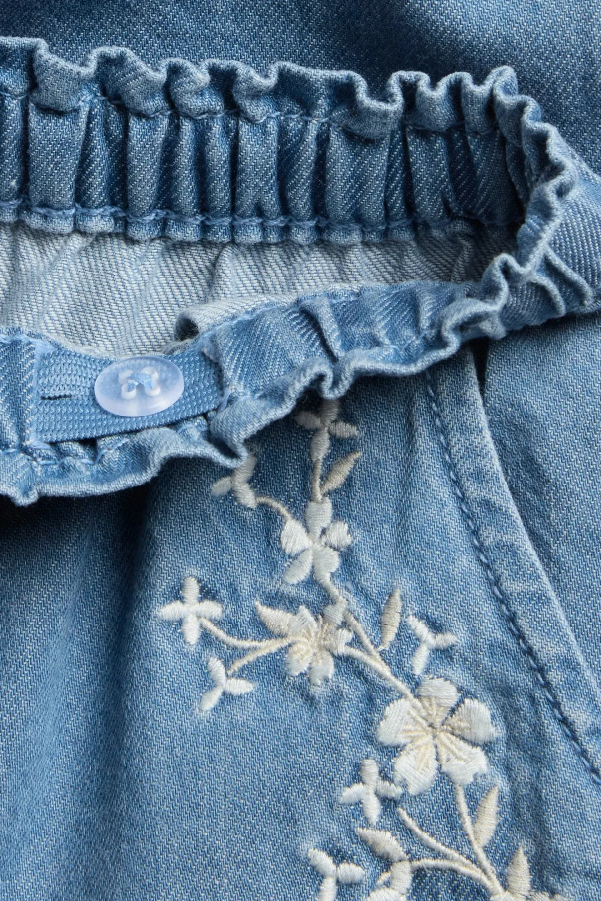 Baby blue denim trousers with floral embroidery