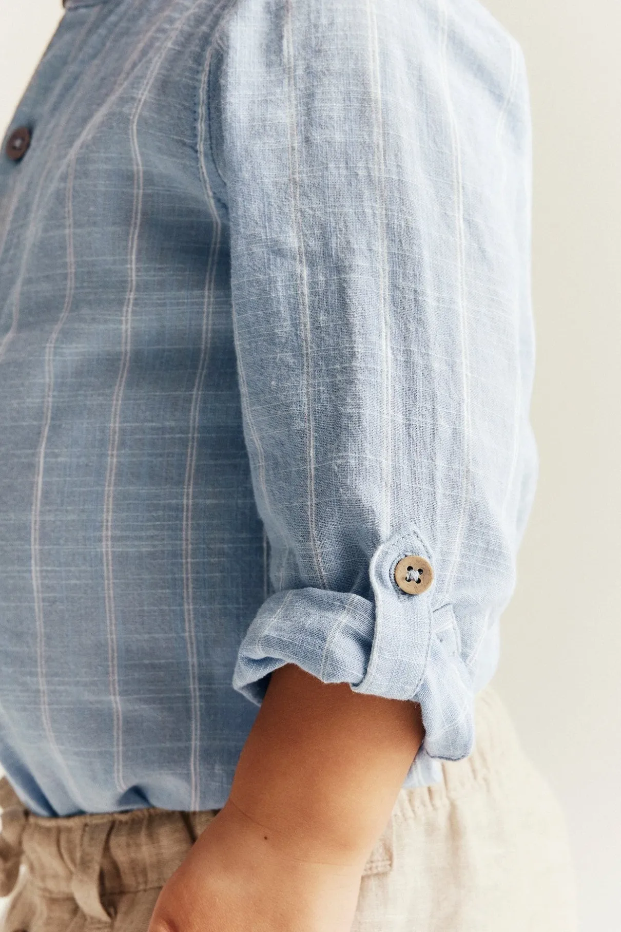 Baby blue striped shirt‑style bodysuit