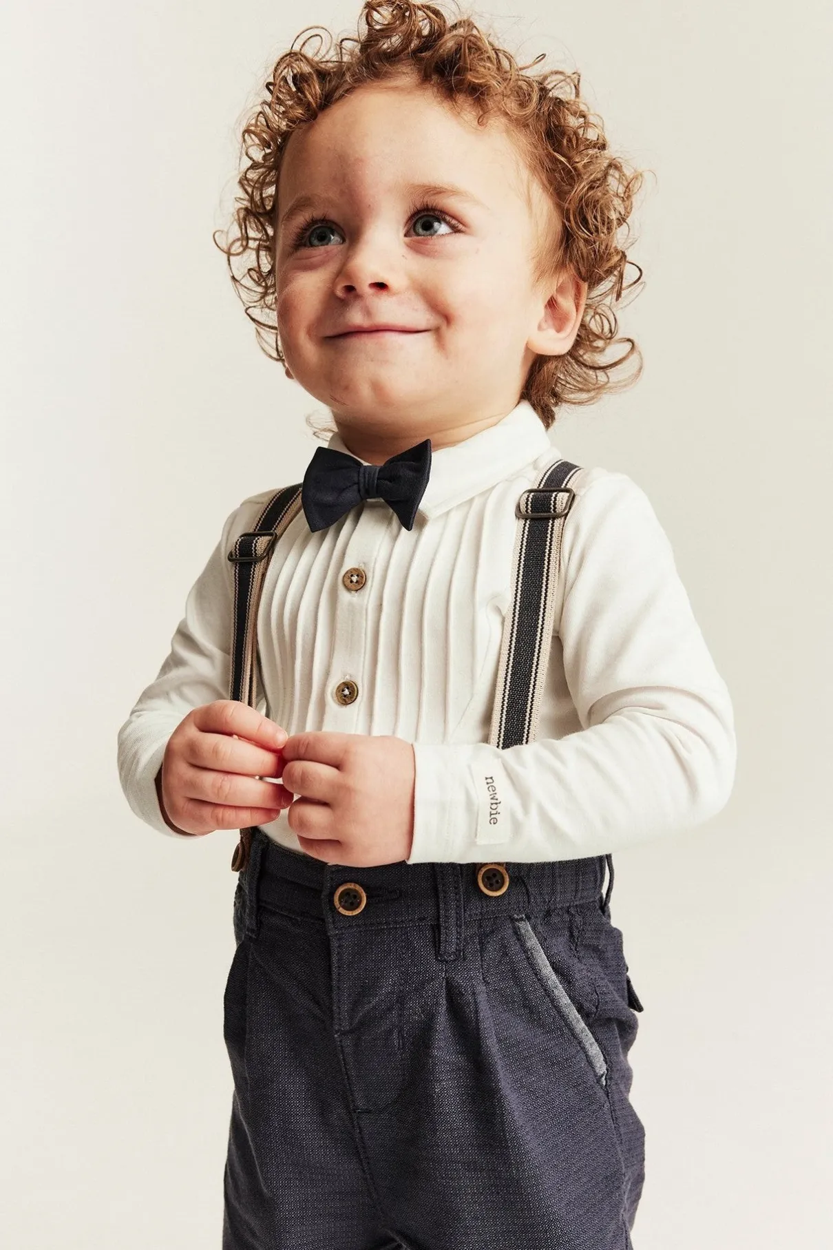 Baby white long-sleeved bodysuit with bow tie