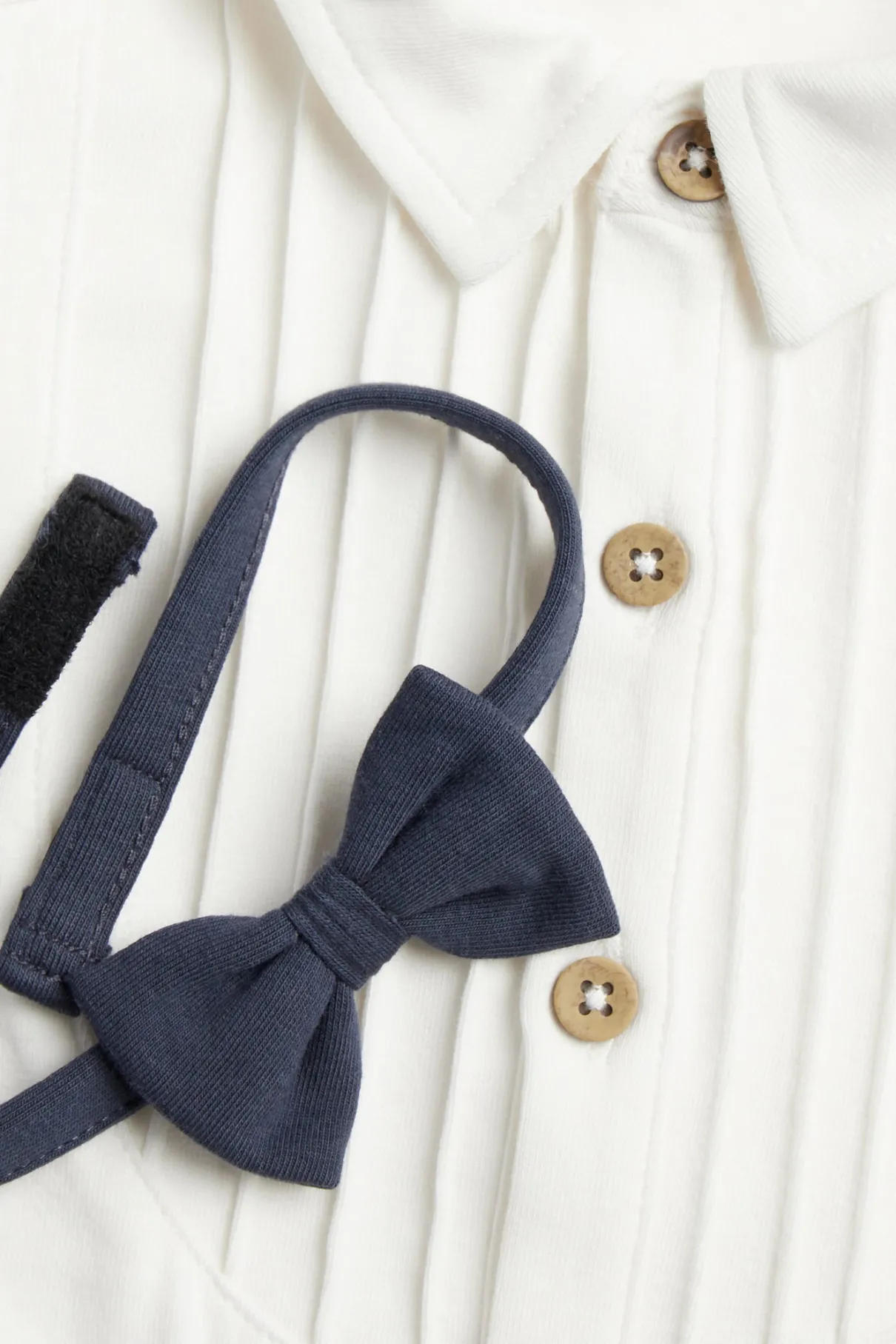 Baby white long-sleeved bodysuit with bow tie