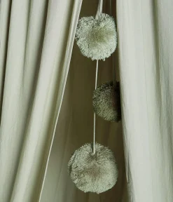 Green reading tent with pom-poms
