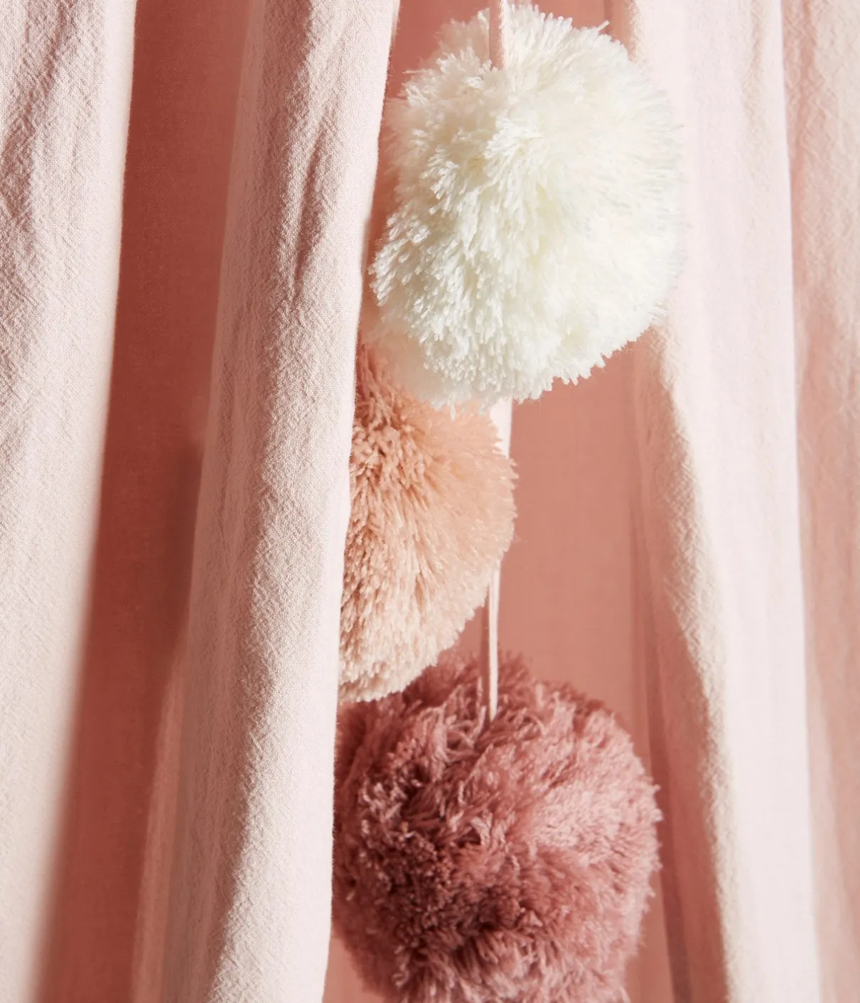 Pink reading tent with pom-poms